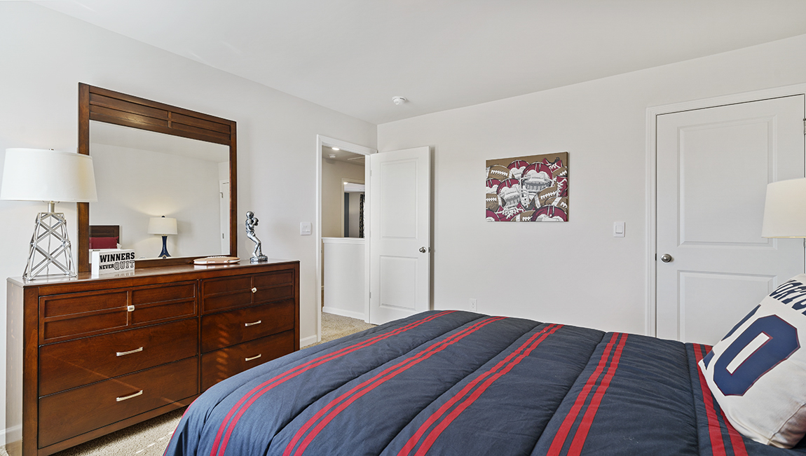 Bedroom with carpet and window.