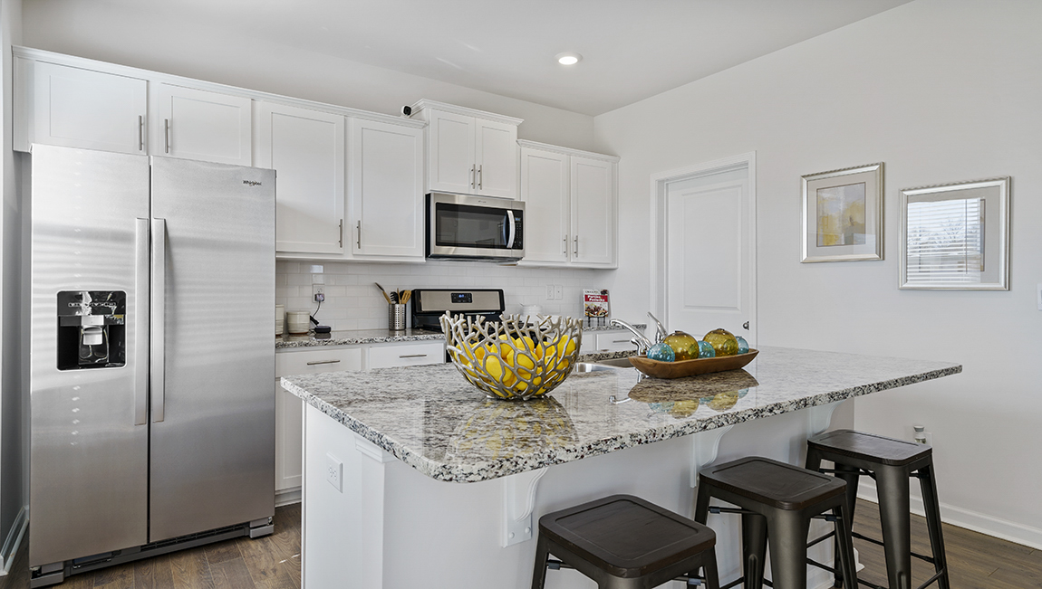 Kitchen and island with granite counter tops.