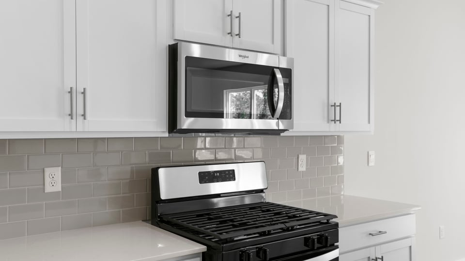 Kitchen with island and stainless steel appliances.