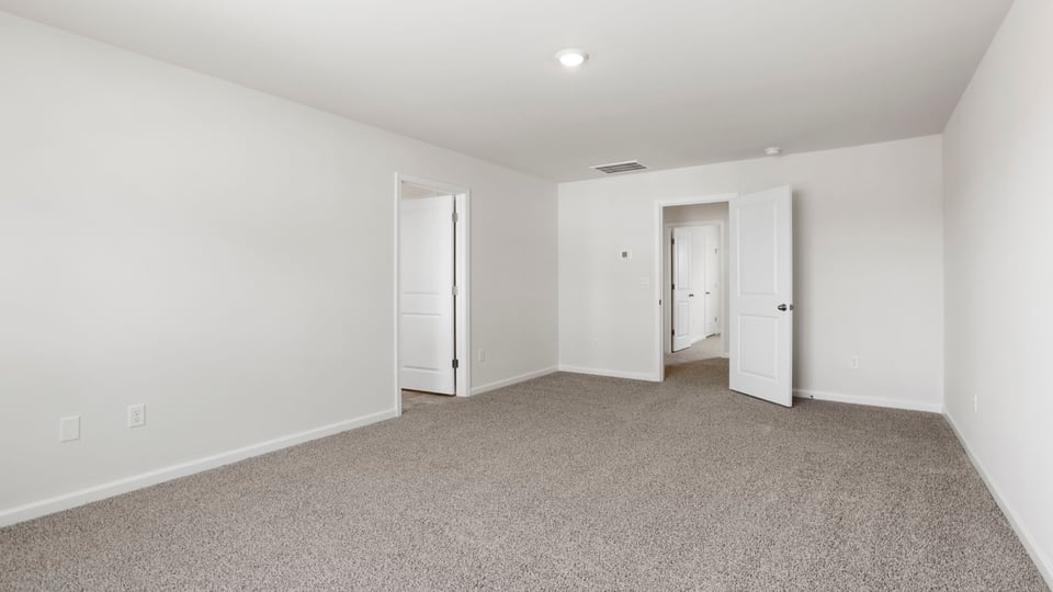 Bedroom with carpet and window.