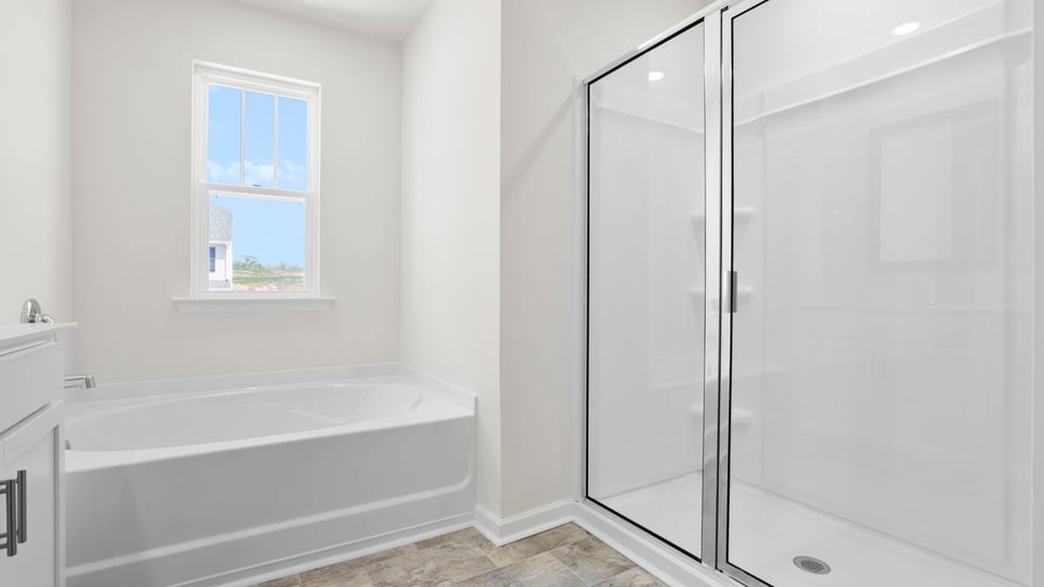 Bathroom with walk in shower and tub.