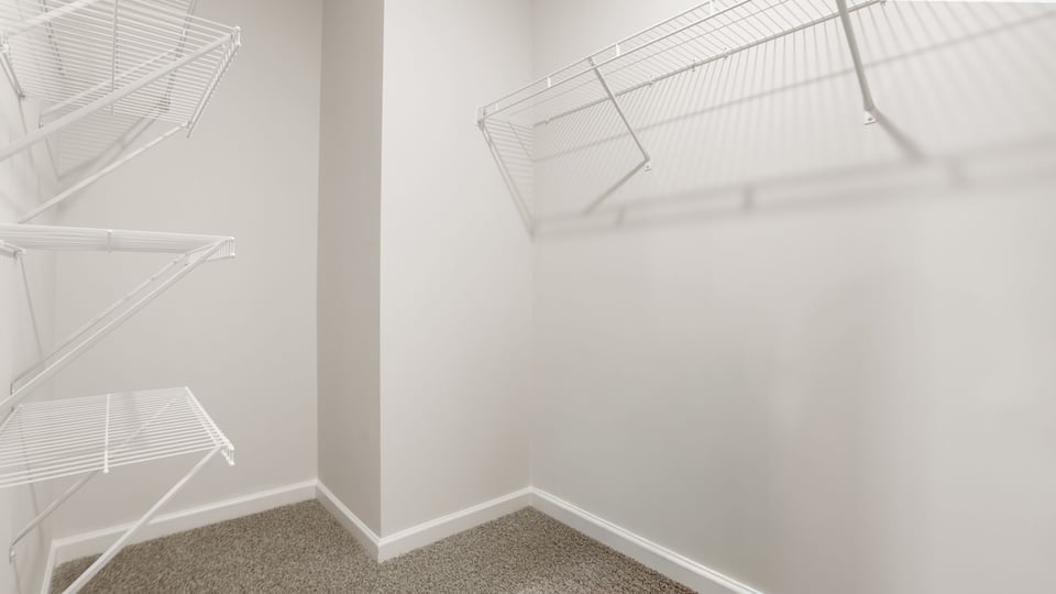 Closet with hanging storage racks.