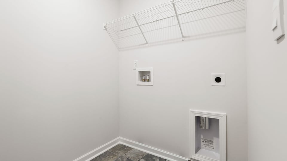 Laundry room with hanging storage racks.