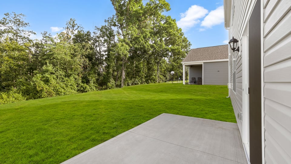 Back exterior with view of large yard