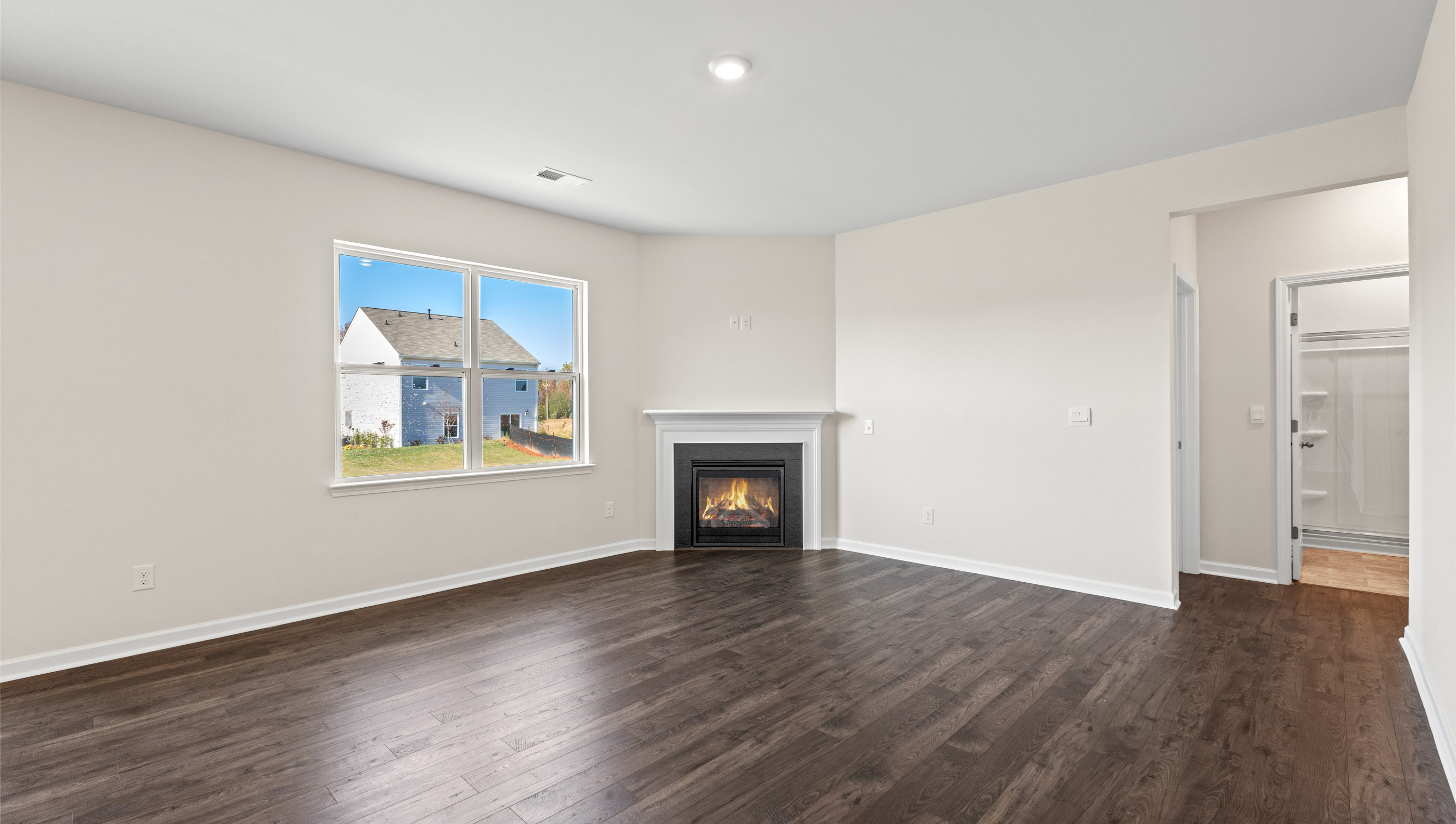 Living room with fireplace and windows.