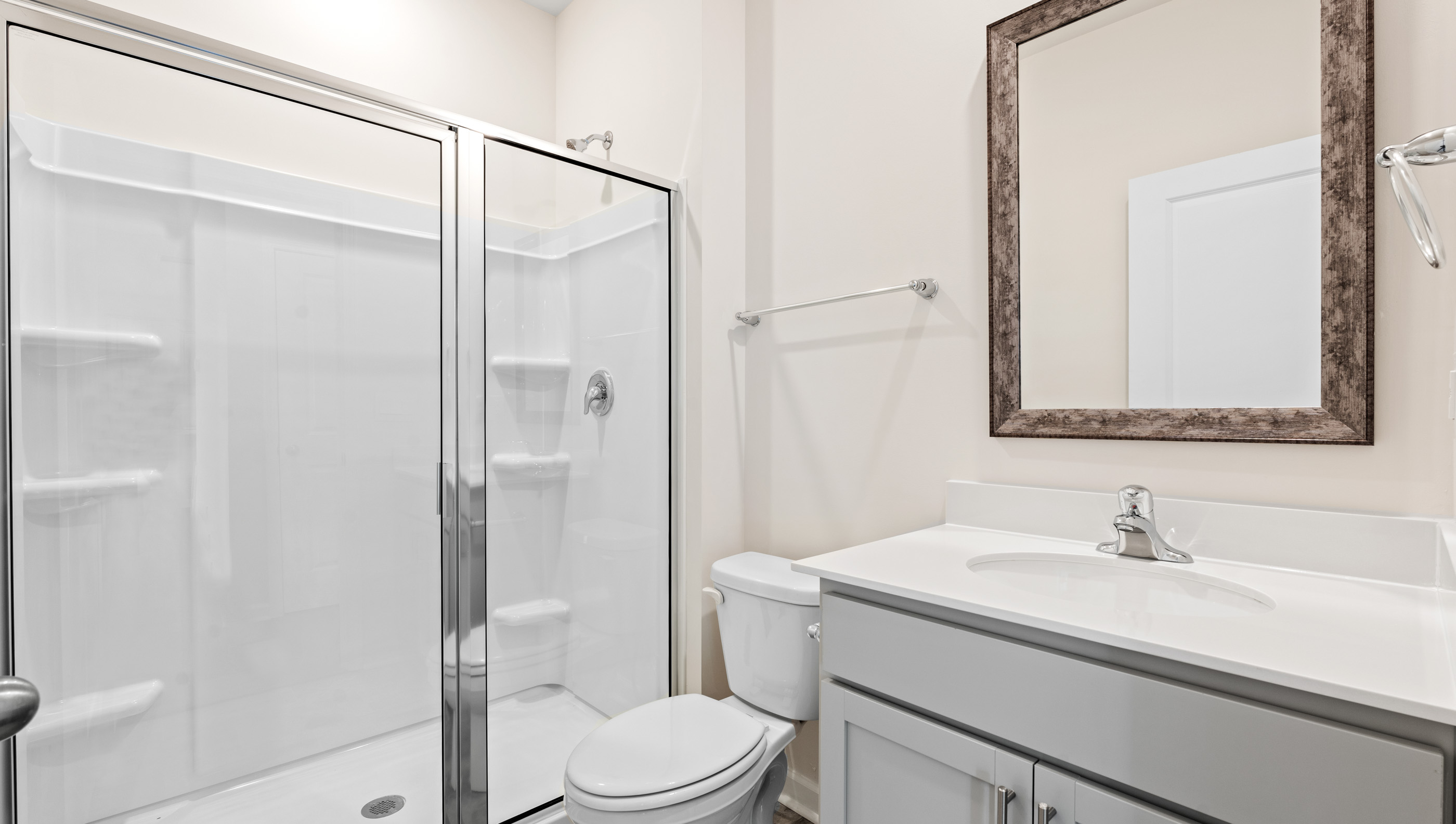 Bathroom with vanity and walk in shower.