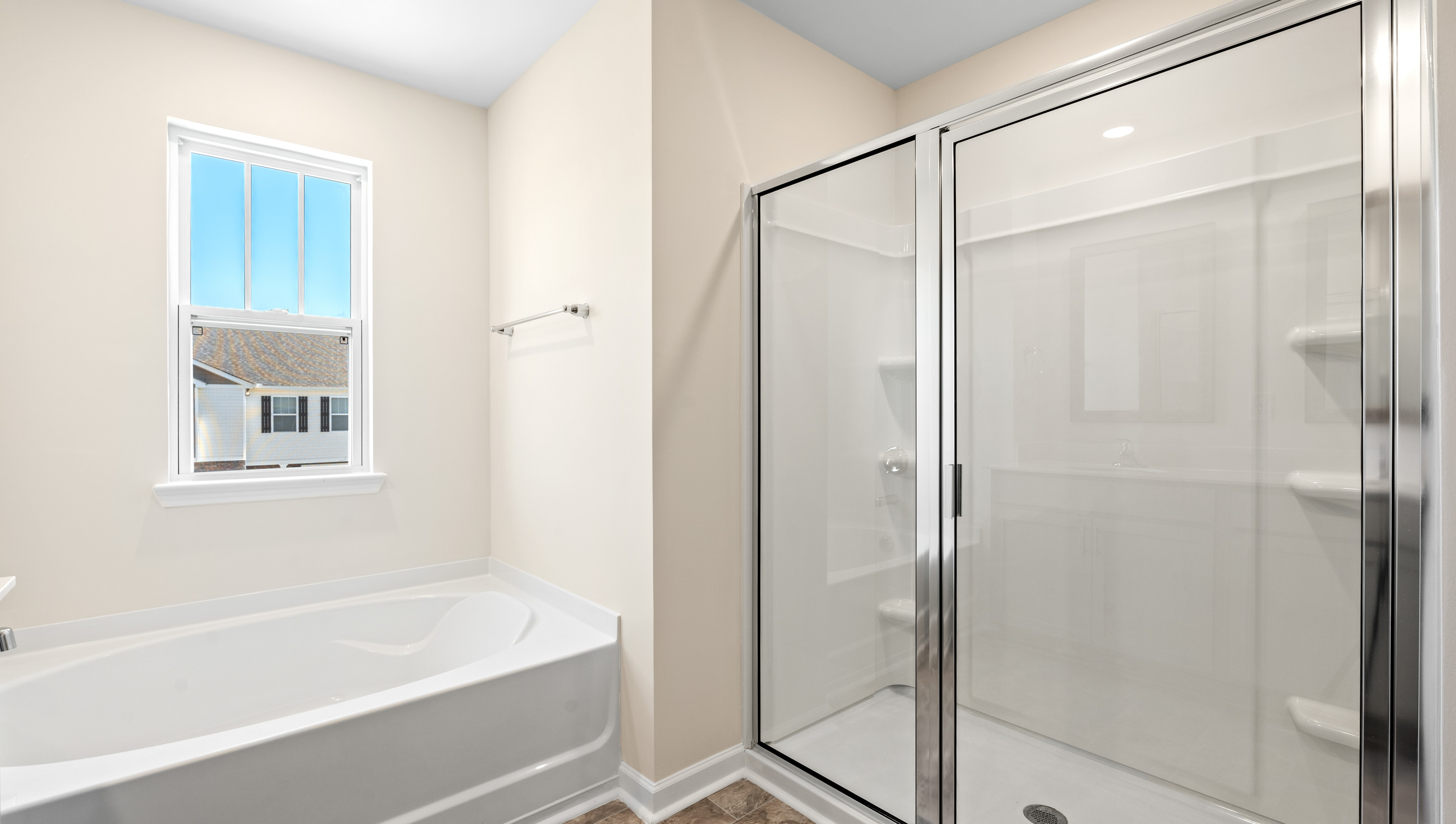 Bathroom with tub and walk in shower.