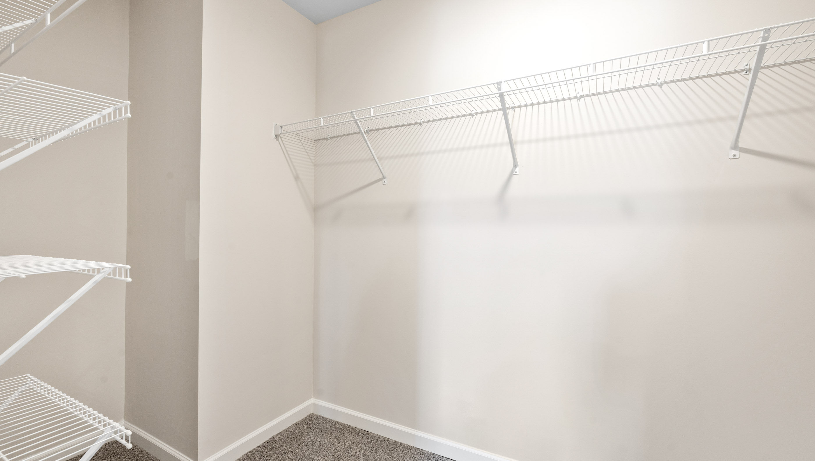 Walk in closet with shelves.