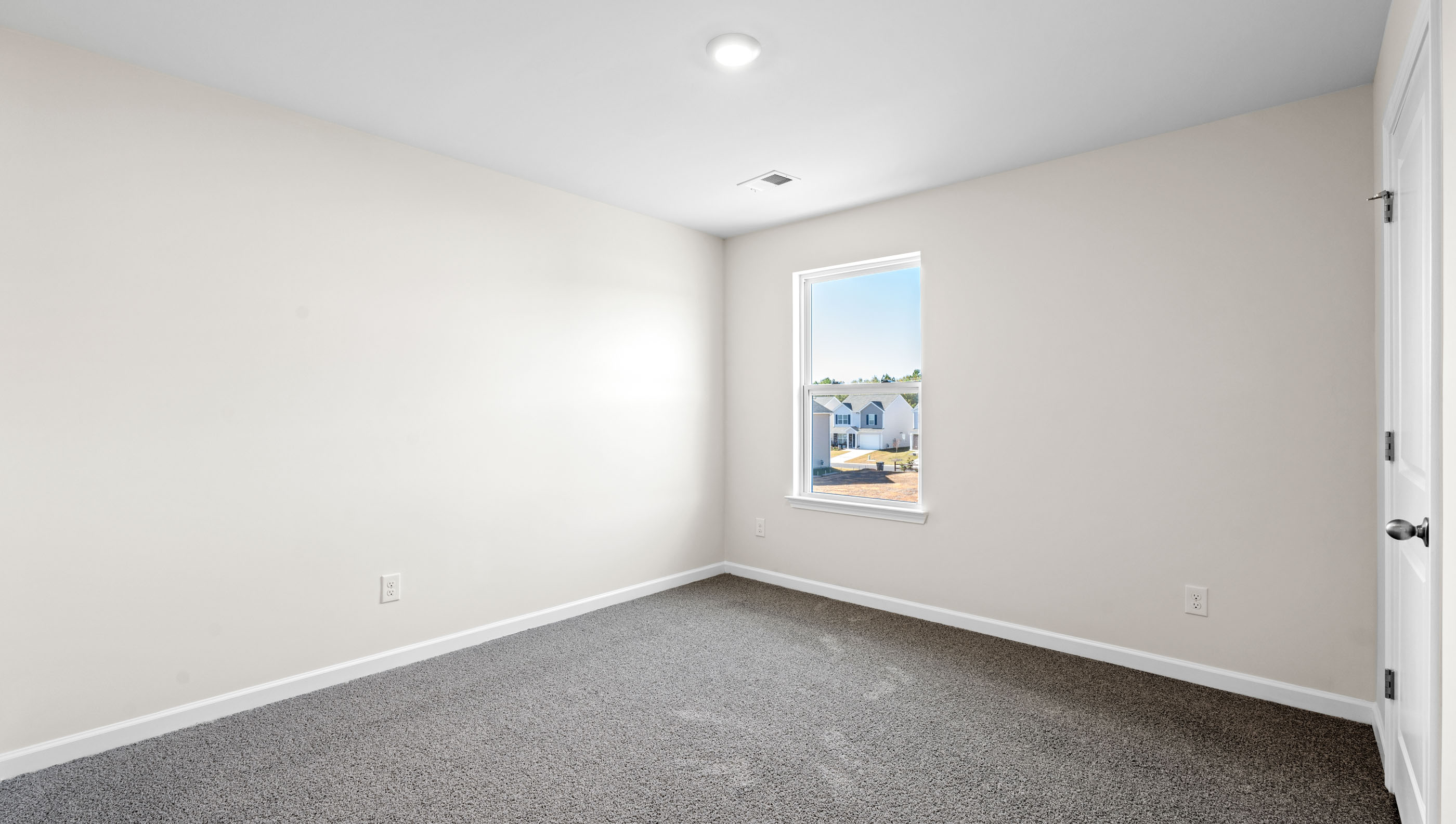 Bedroom with carpet and window.