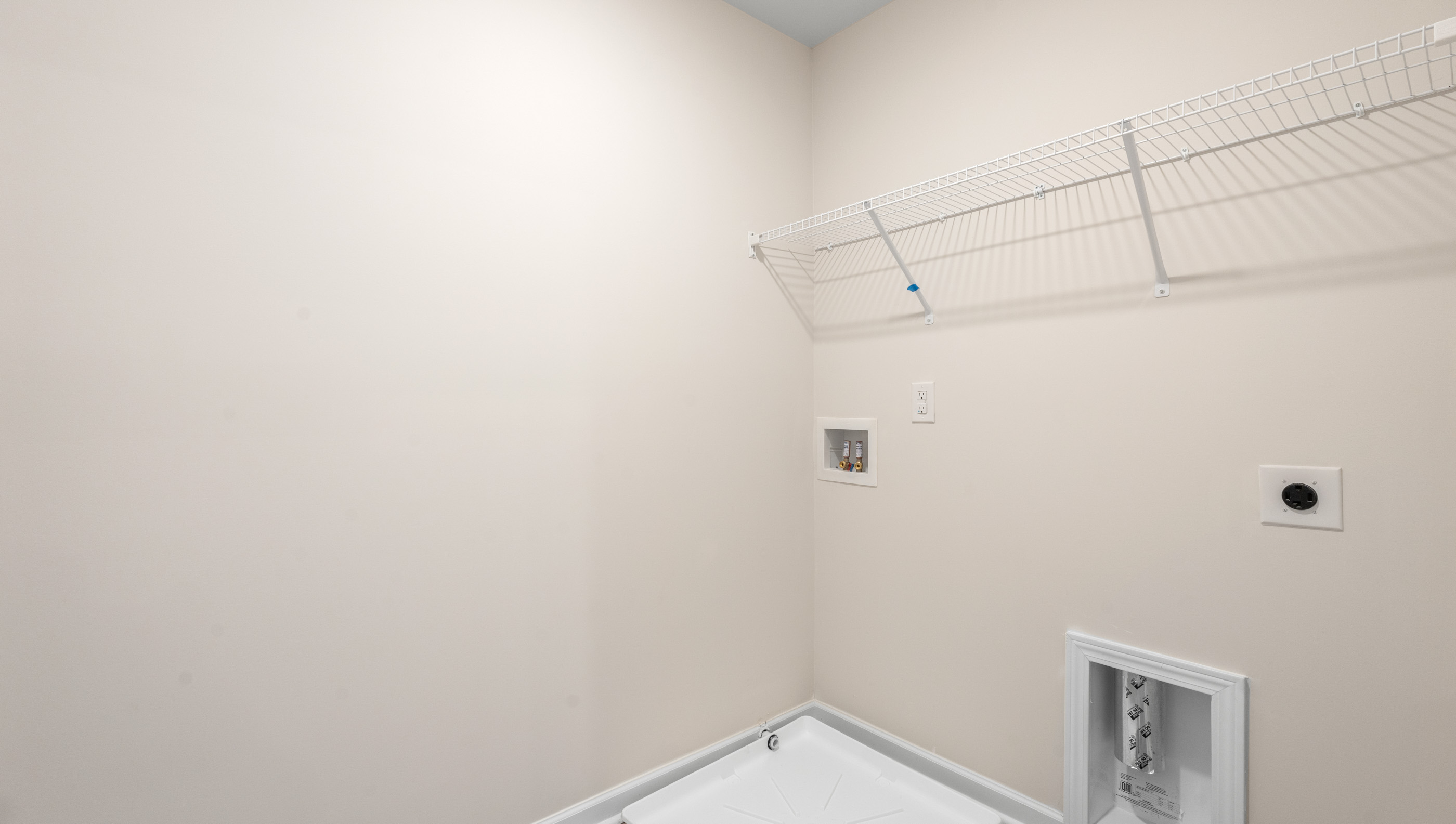 Walk in laundry with shelves.