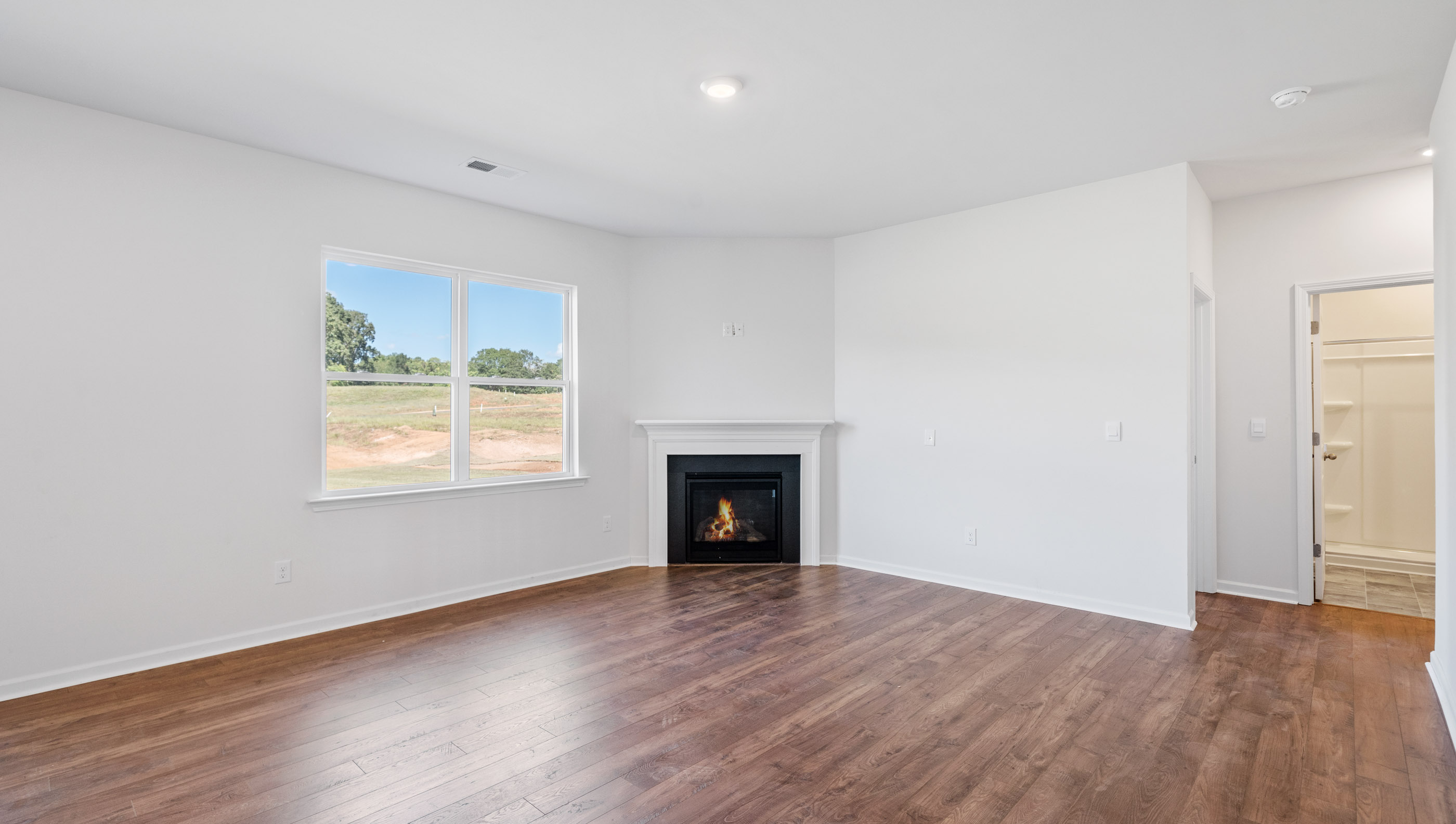 Living room with fireplace and windows.