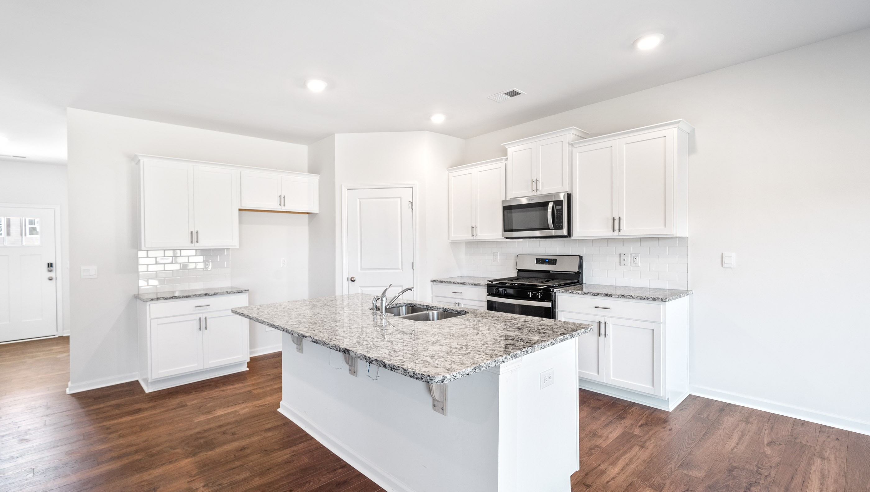 Kitchen and island with granite countertops.