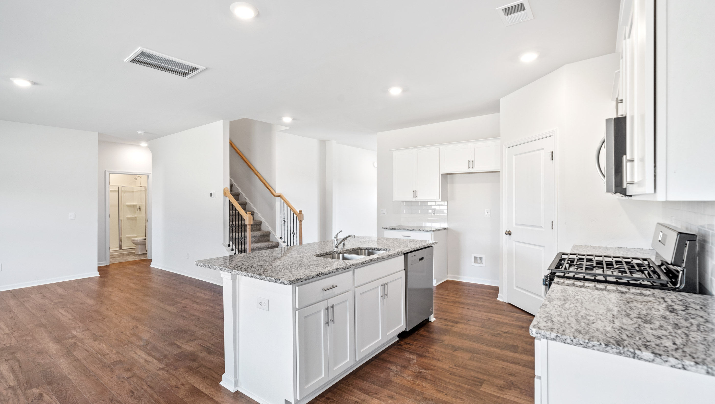 Kitchen and island with granite countertops.