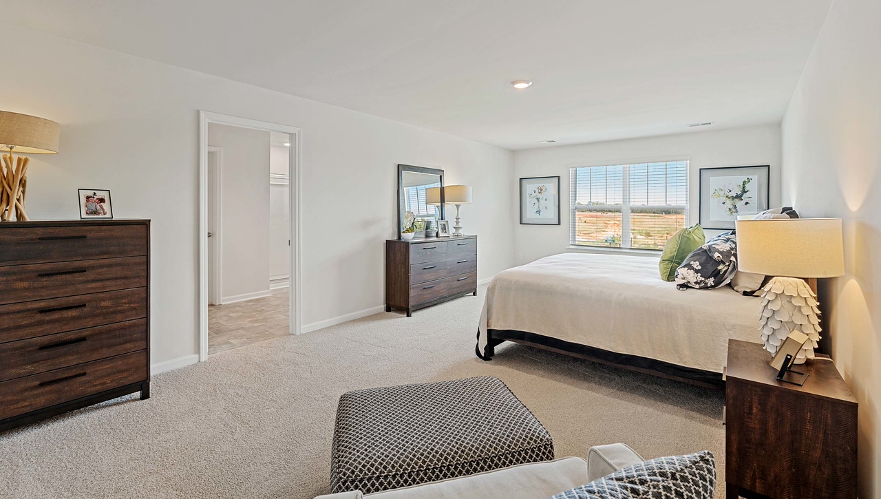 Bedroom with carpet and window.