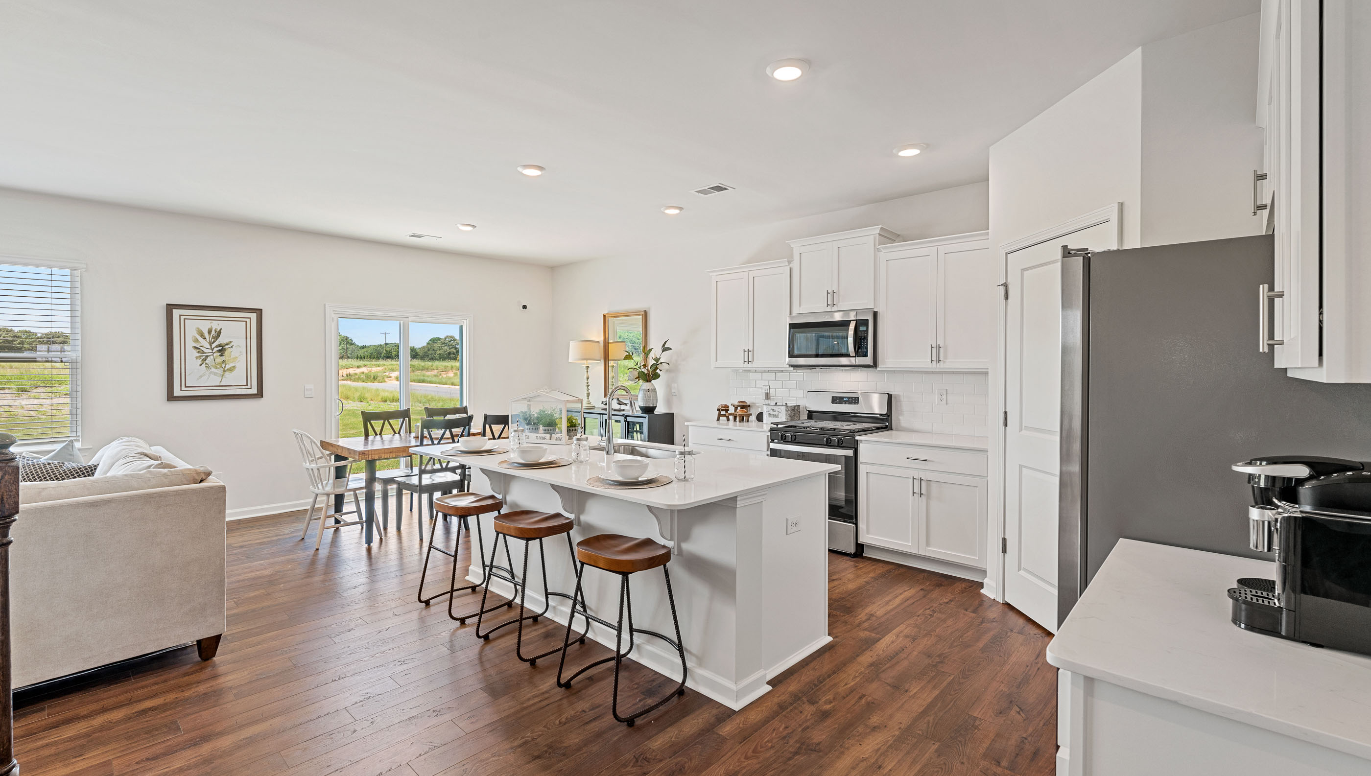 Kitchen and island with quartz countertops and stainless steel appliances.