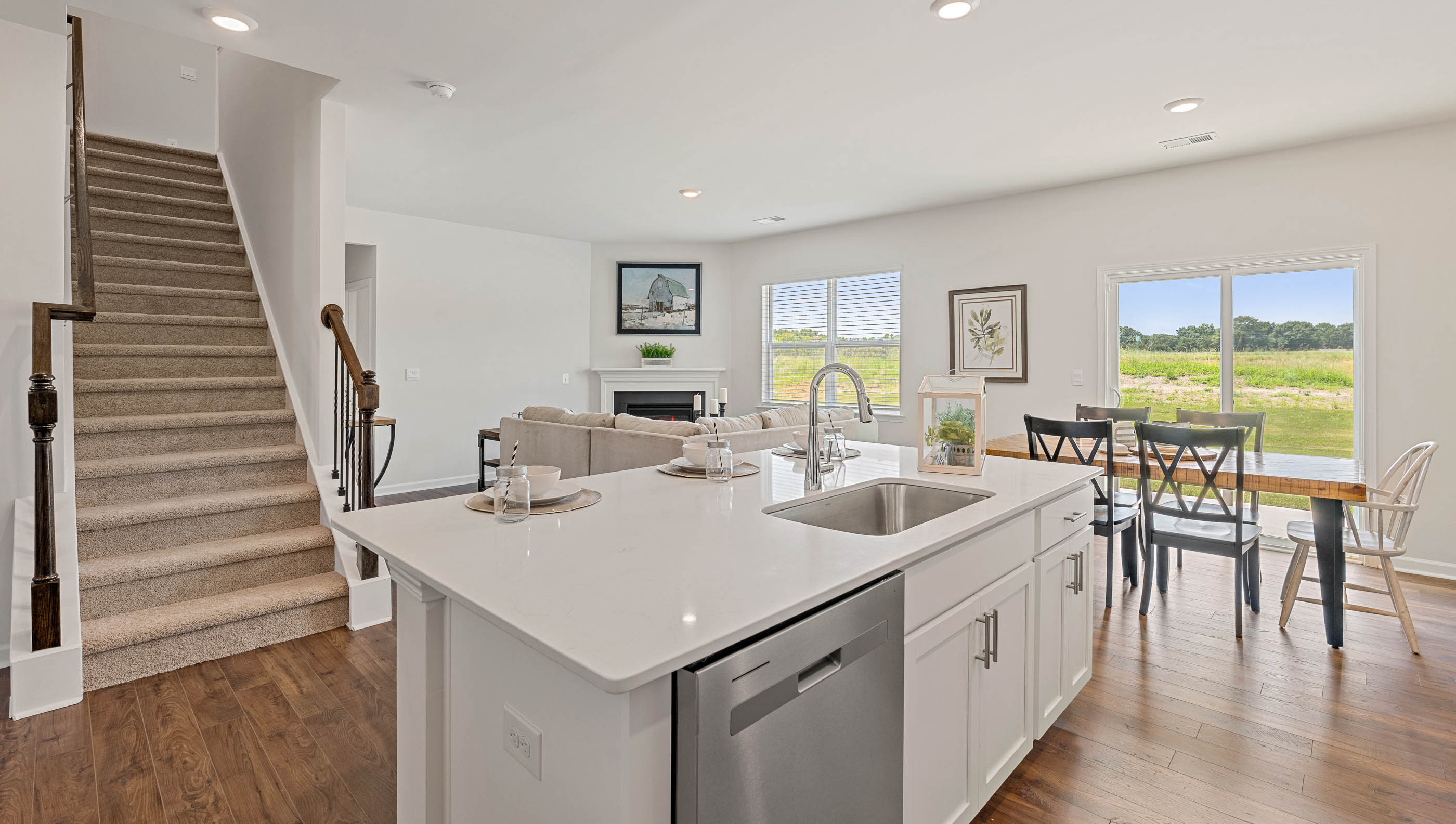 Kitchen and island with quartz countertops and stainless steel appliances.