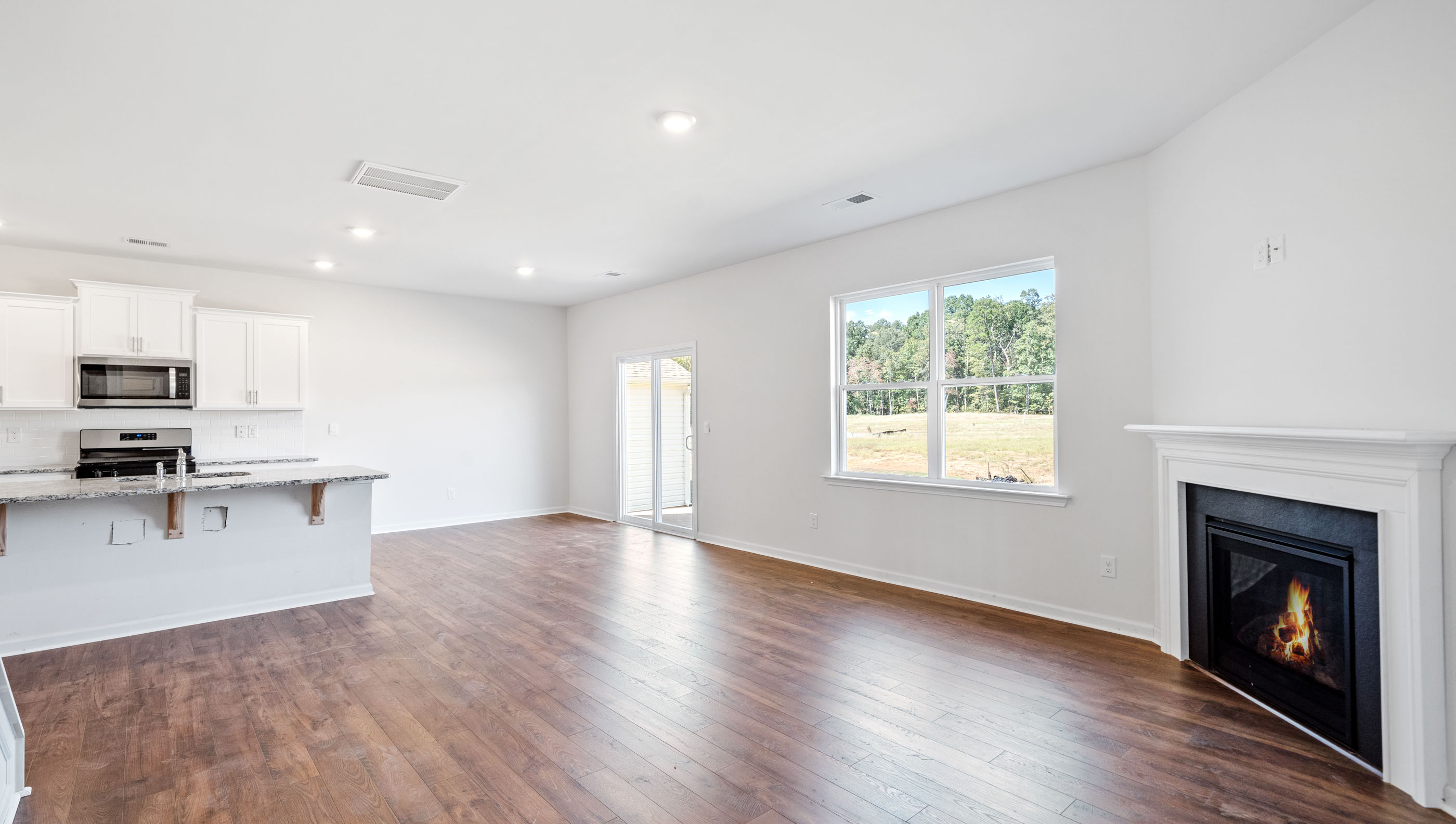 Living room with fireplace and windows.