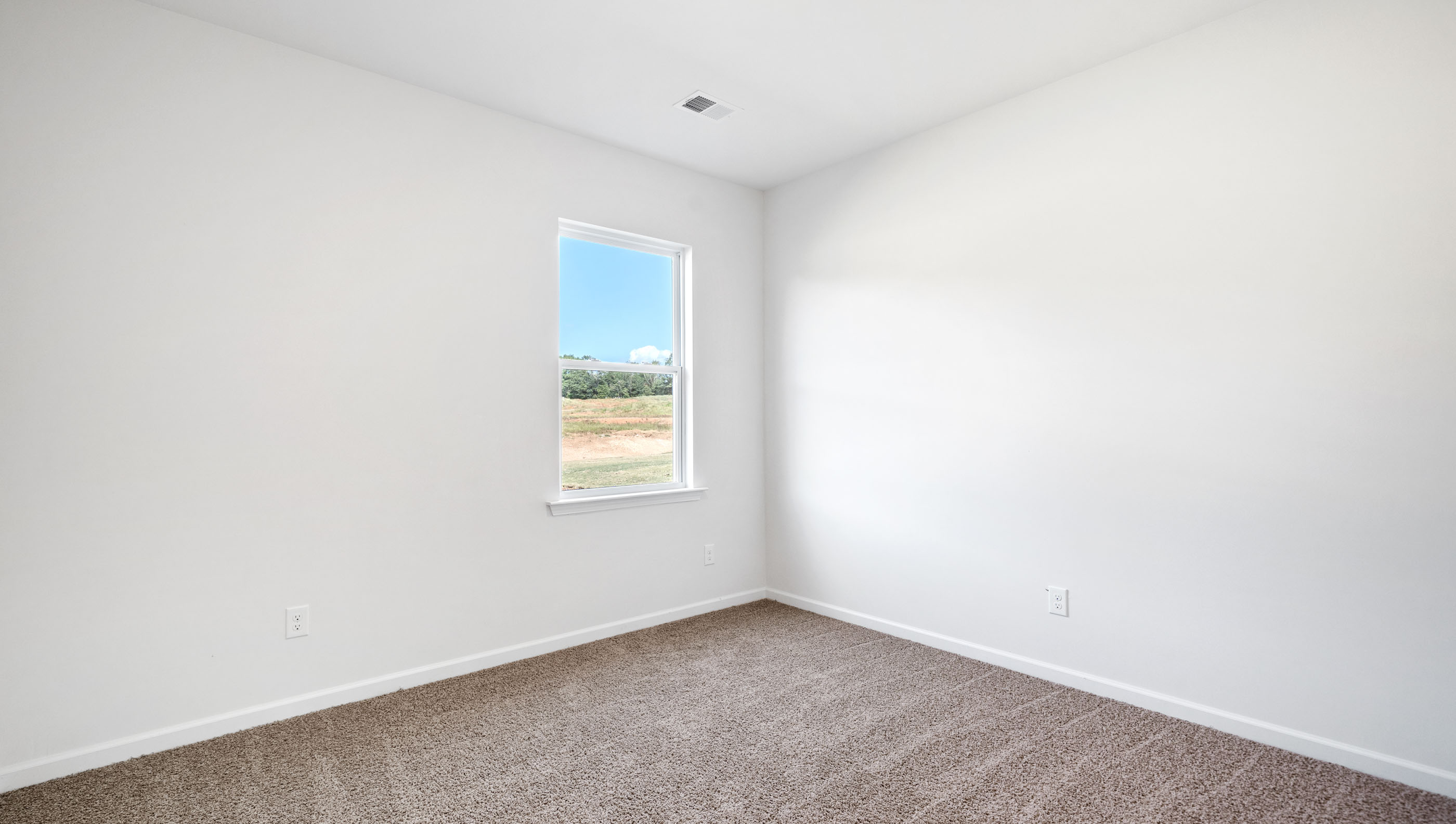 Bedroom with carpet and window.