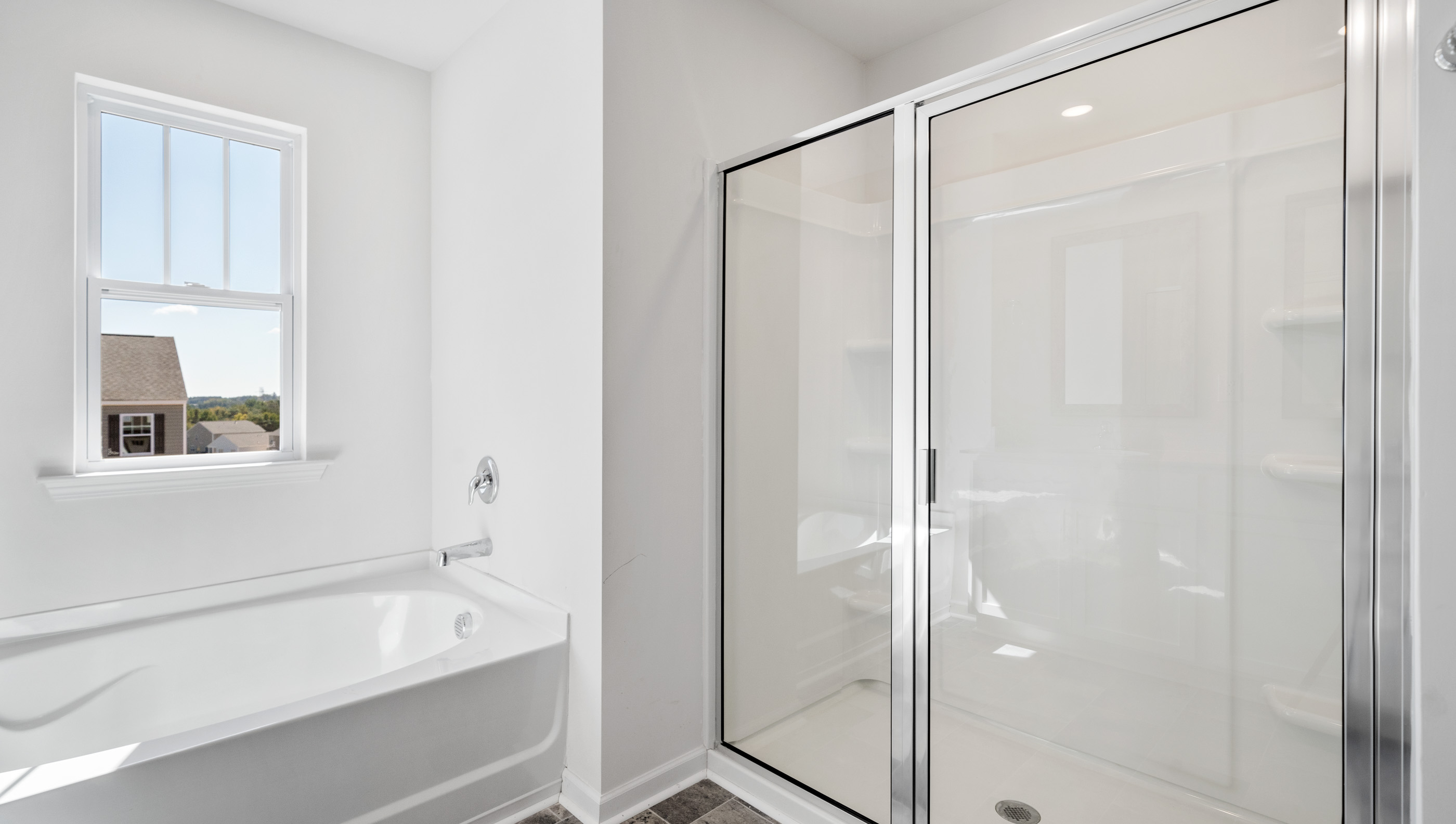 Bathroom with tub and walk in shower.