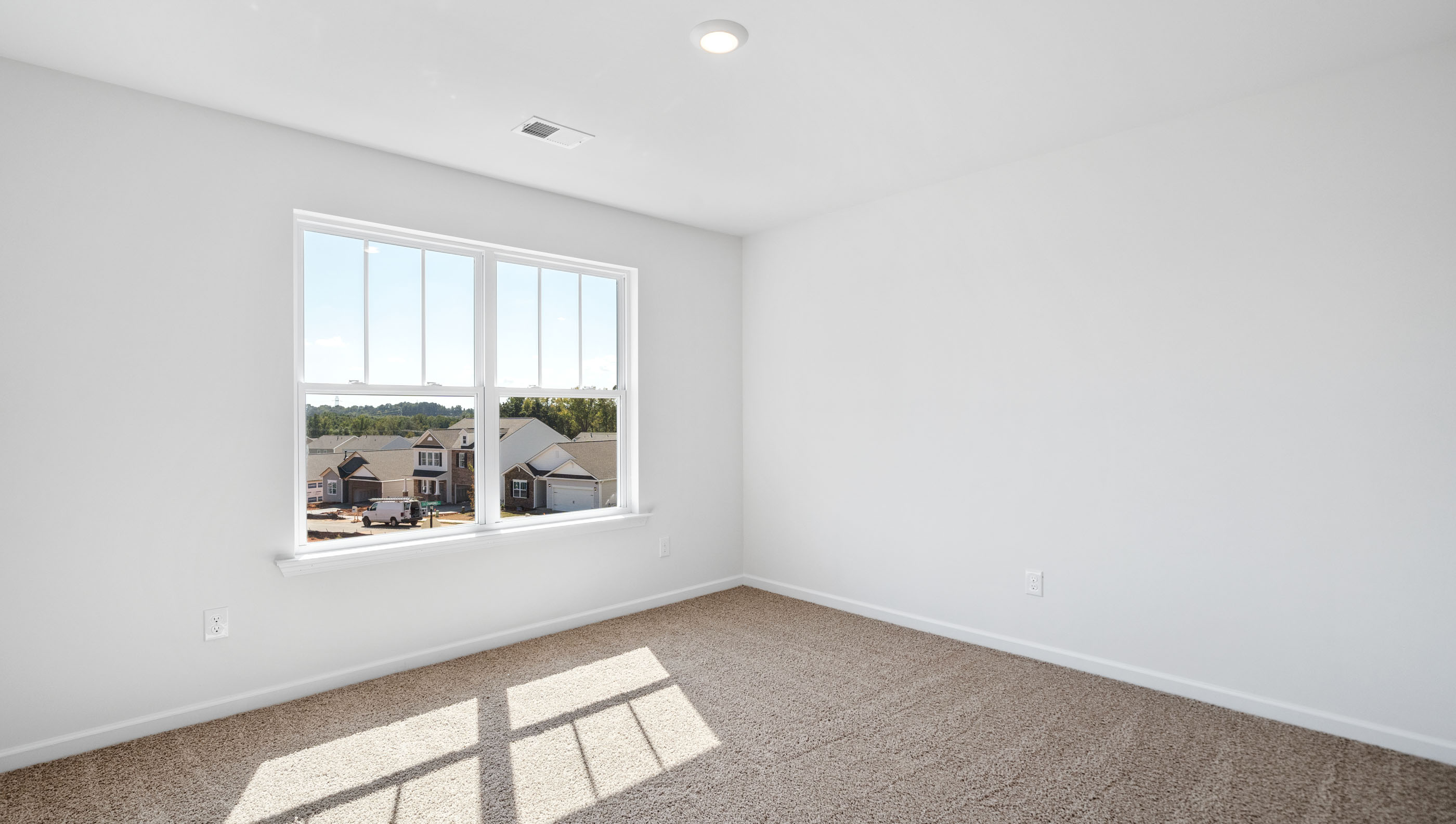Bedroom with carpet and window.