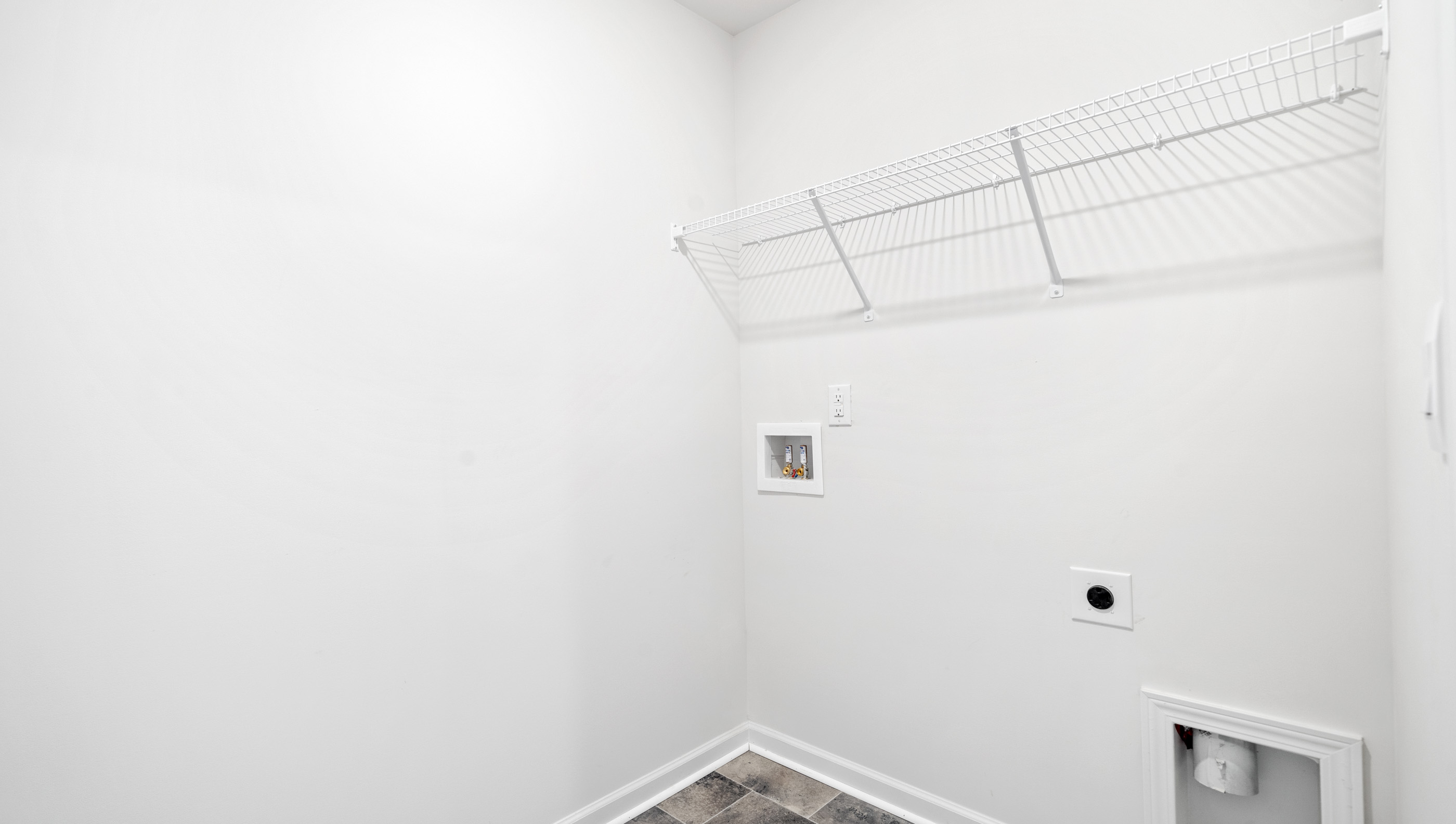 Walk in laundry with shelves.