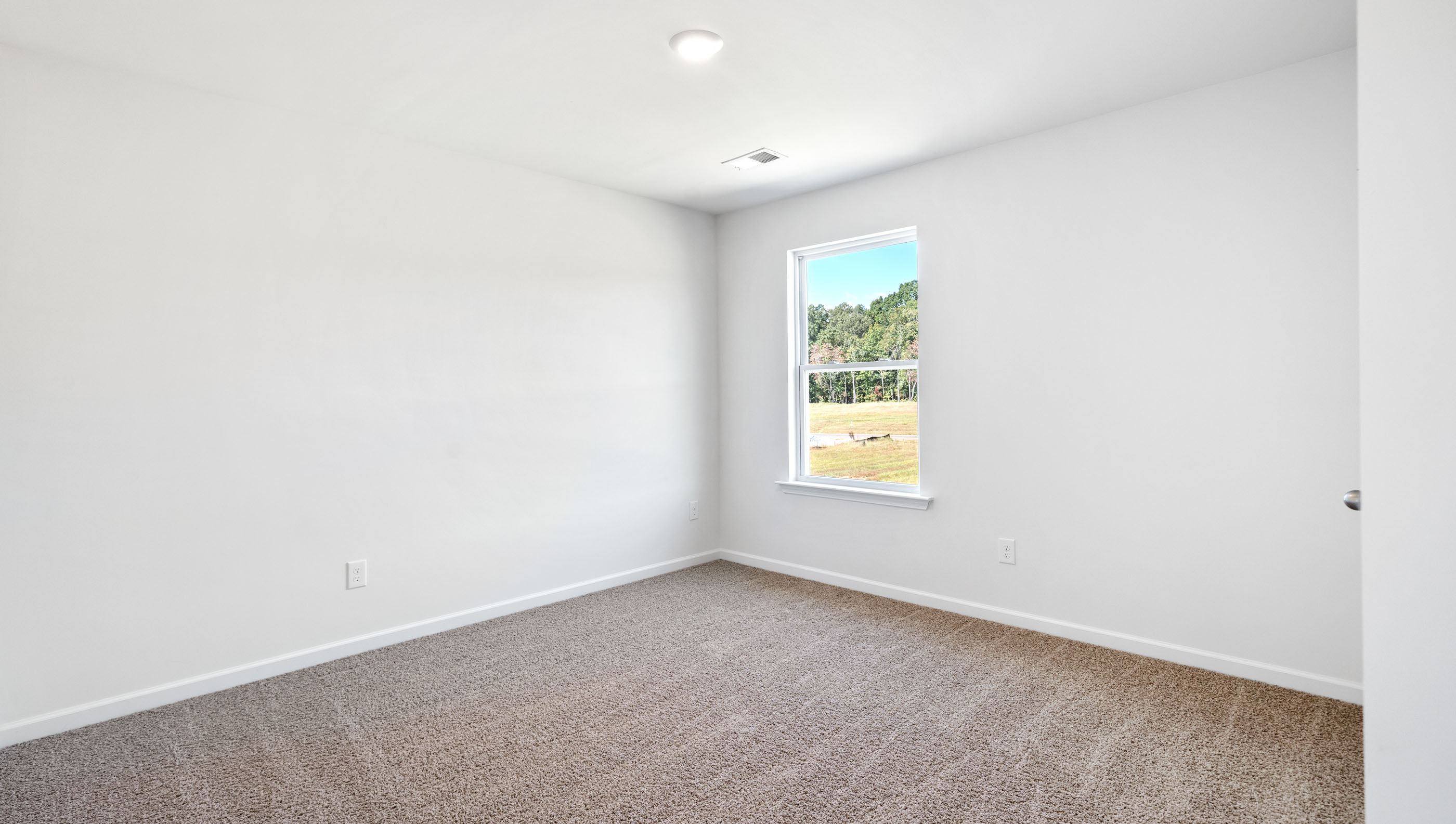 Bedroom with carpet and window.