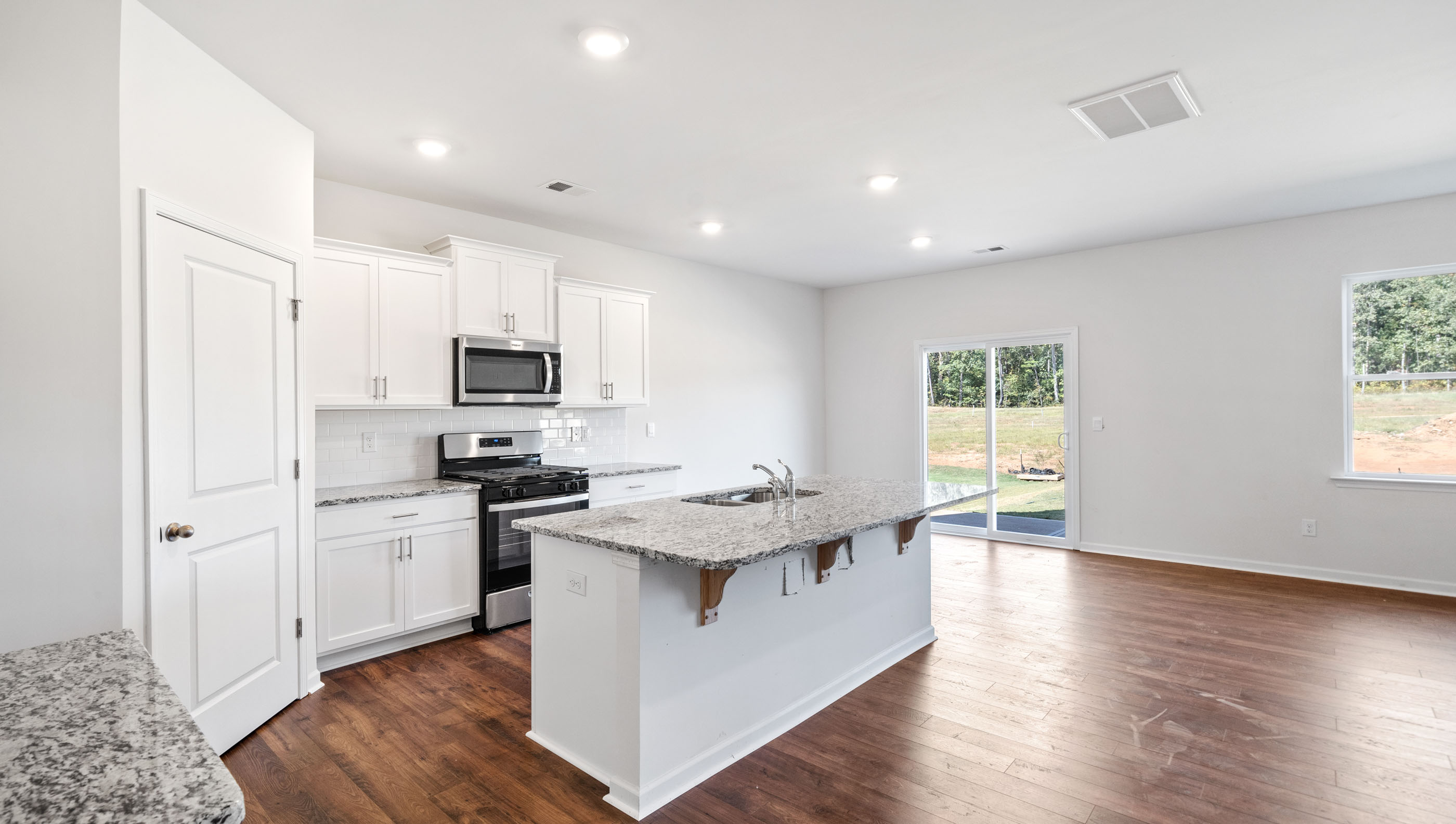 Kitchen and island with granite countertops.