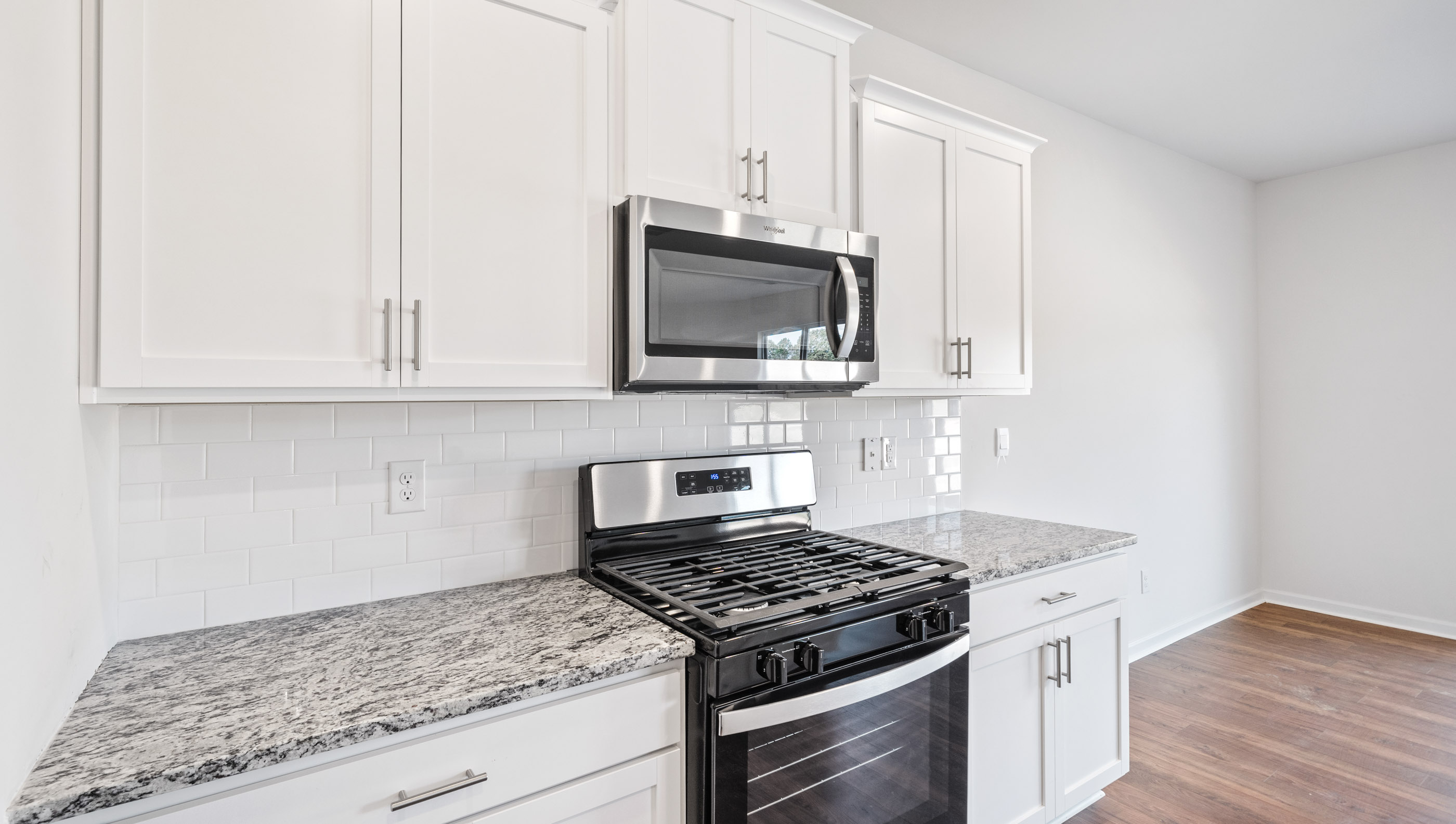 Kitchen with granite countertops and stainless steel appliances.