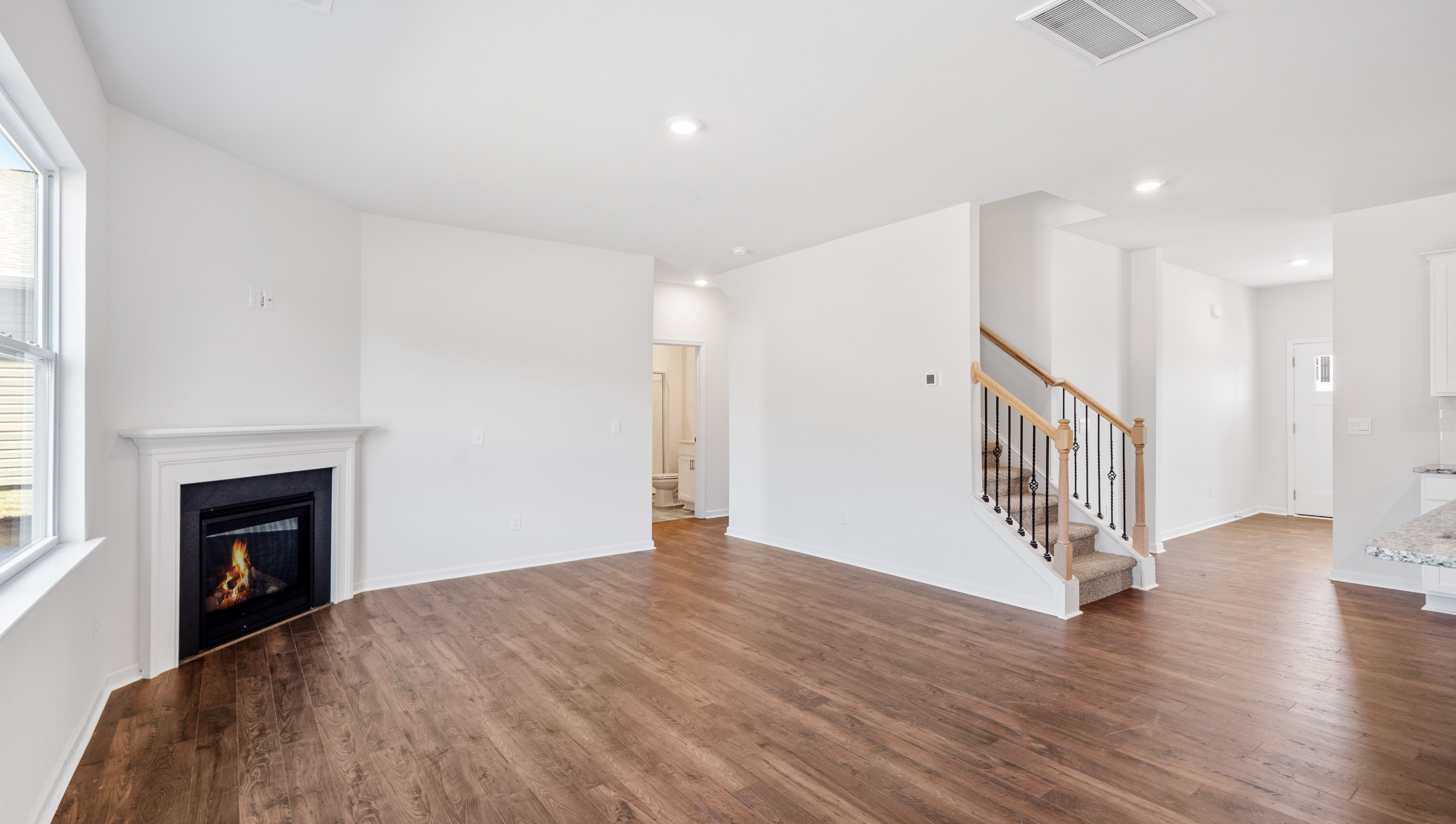 Living room with fireplace and windows.