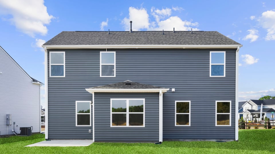 Back exterior of home with large backyard.