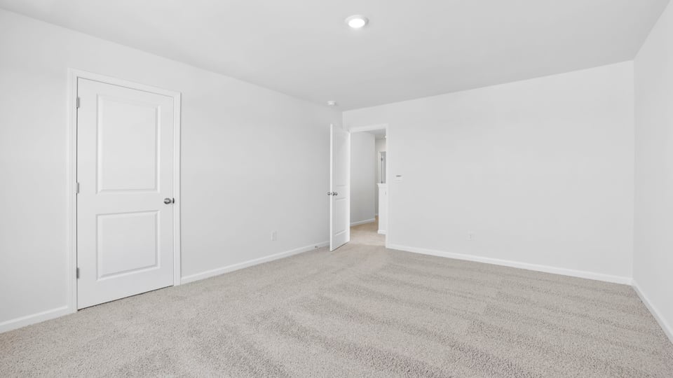 Bedroom with carpet and window.