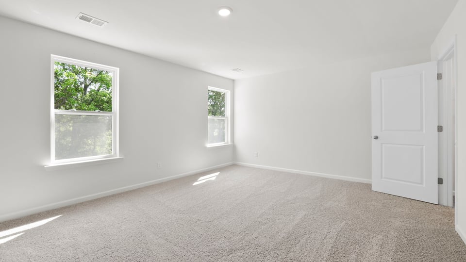 Bedroom with carpet and window.