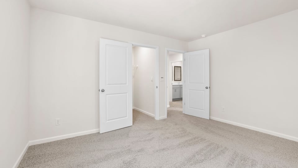 Bedroom with carpet and window.