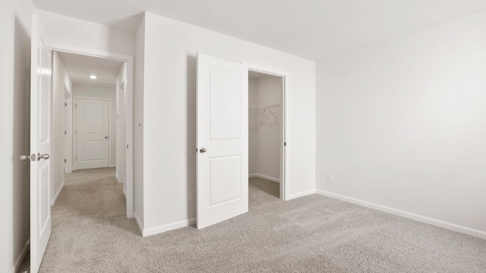 Bedroom with carpet and window.