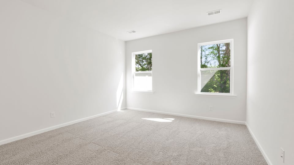 Bedroom with carpet and window.