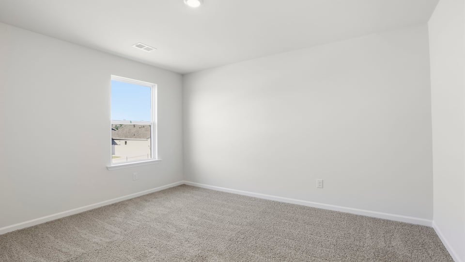 Bedroom with carpet and window.