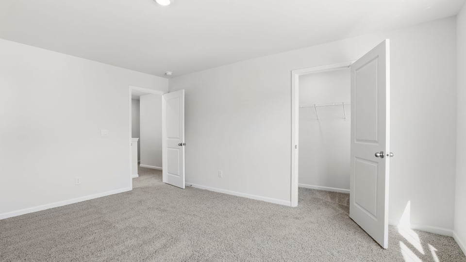 Bedroom with carpet and window.