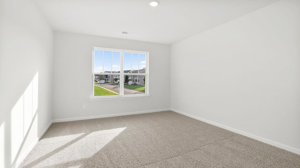 Bedroom with carpet and window