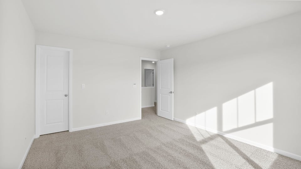 Bedroom with carpet and closet