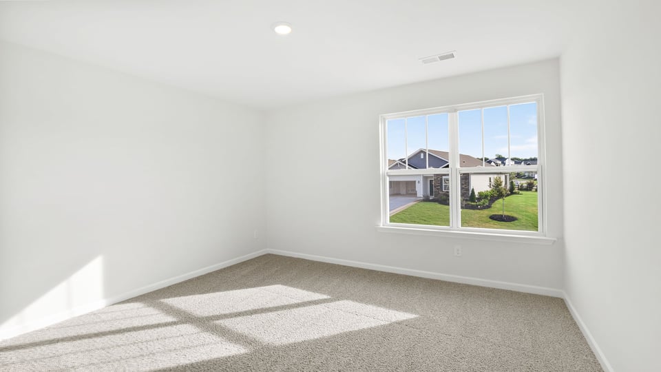 Bedroom with carpet and window