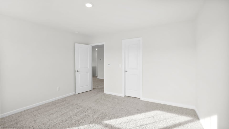 Bedroom with carpet and closet