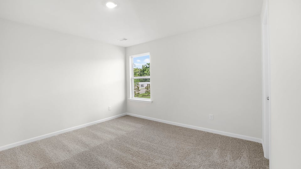 Bedroom with carpet and window
