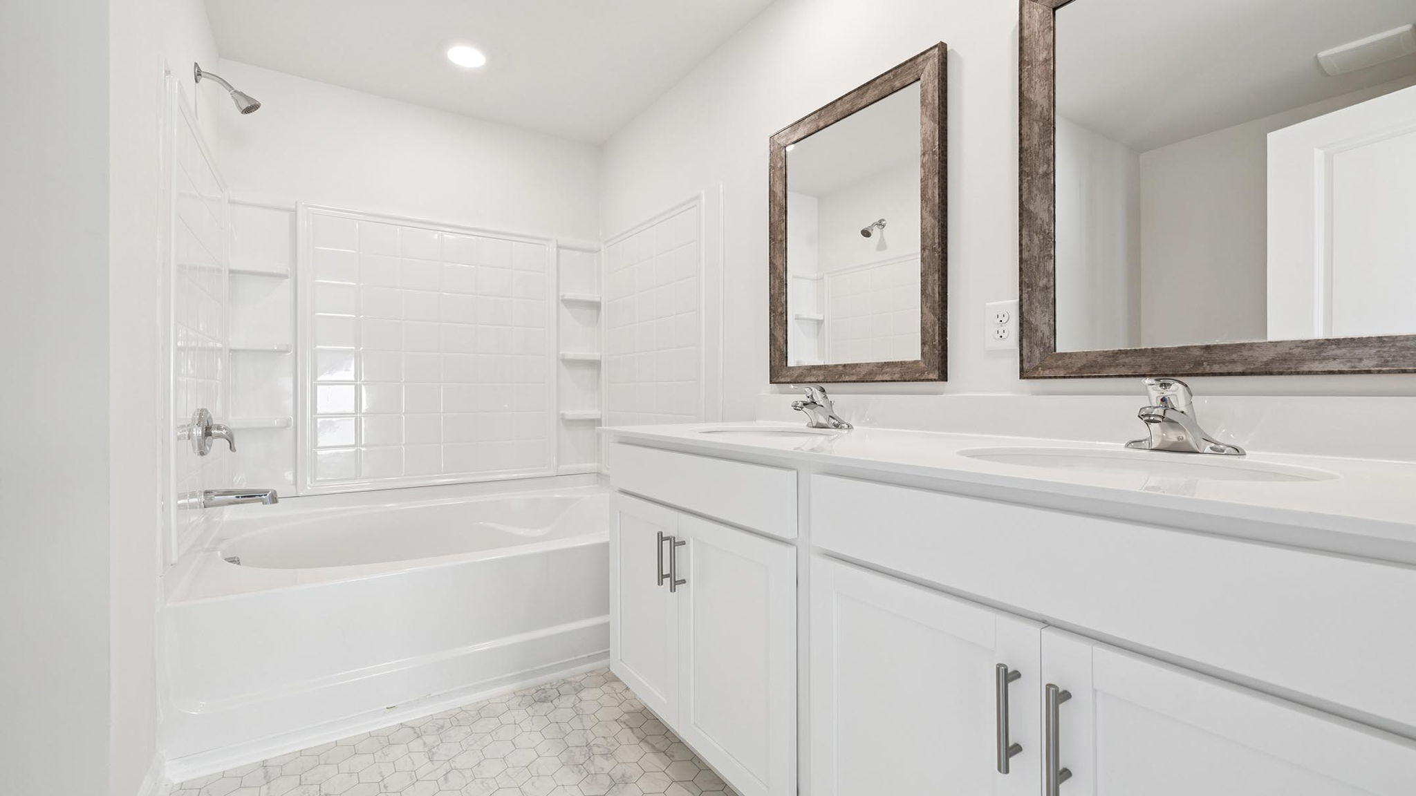 Bathroom with double vanity sink and shower.