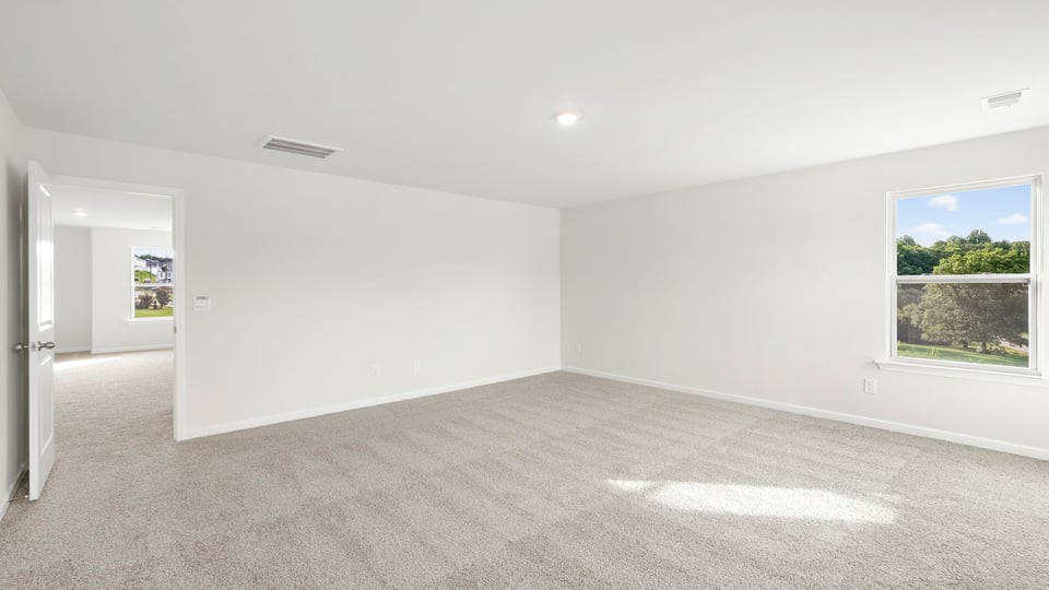 Primary bedroom with carpet and closet