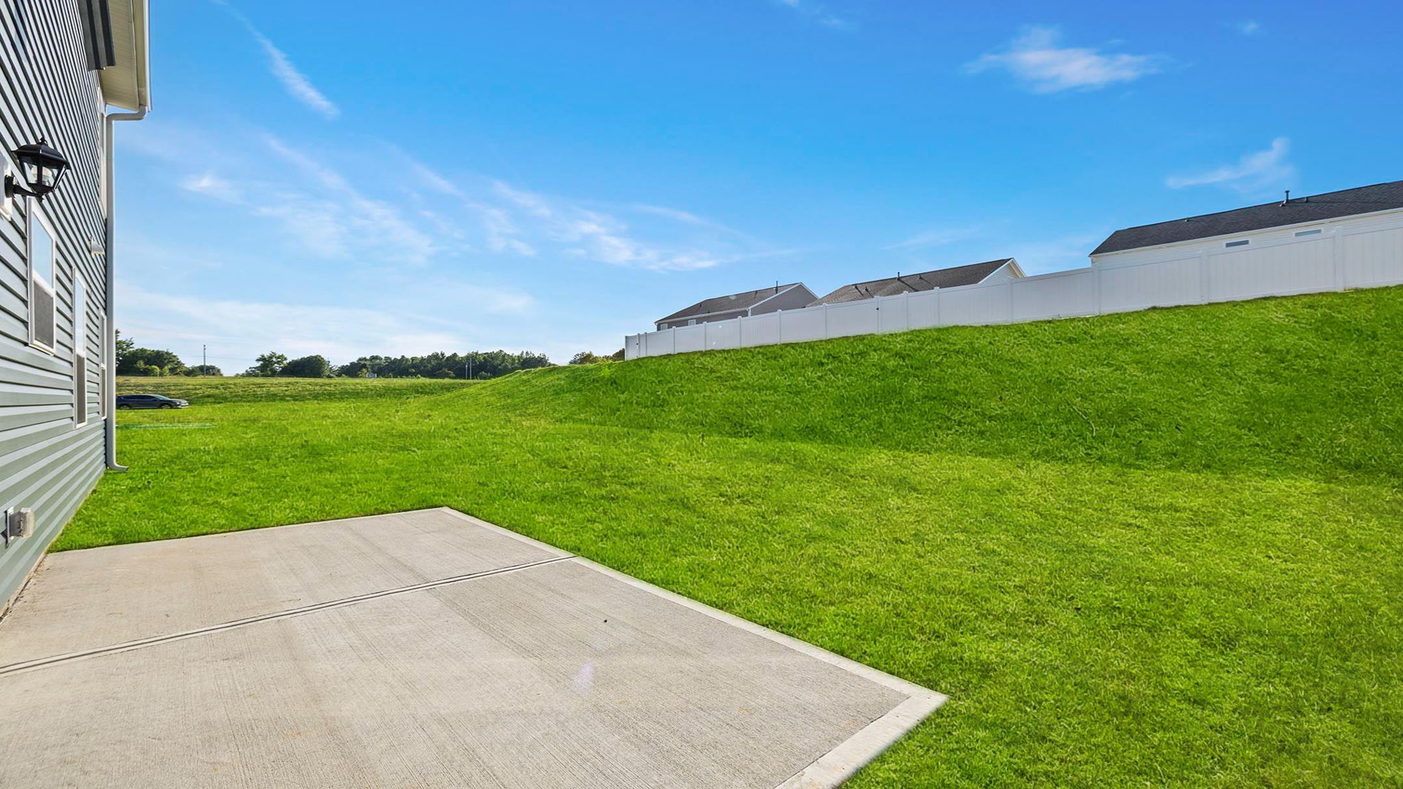 Back exterior of home with patio.