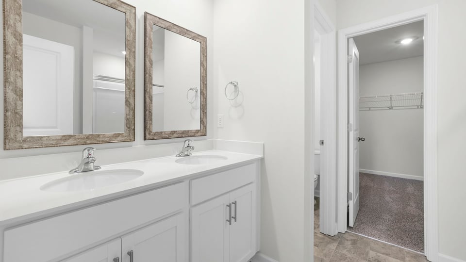 Primary bathroom with double vanity sink and closet