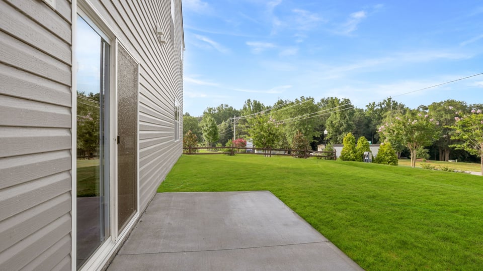Back of the exterior with view of large yard