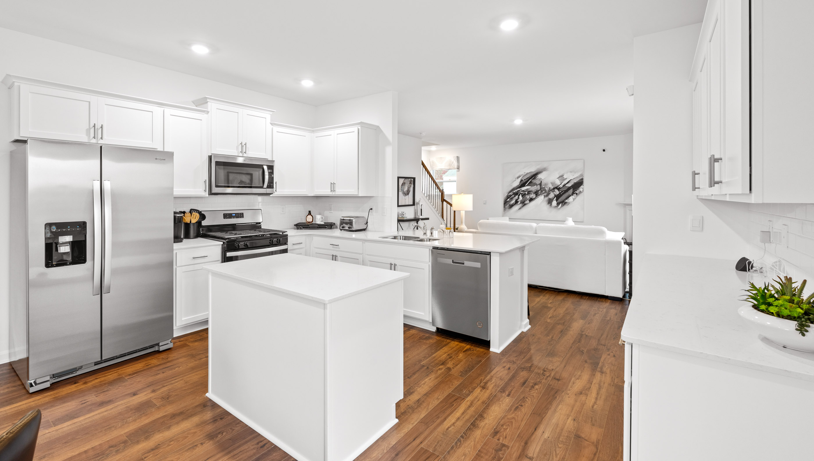 Kitchen with quartz countertops and stainless steel appliances.
