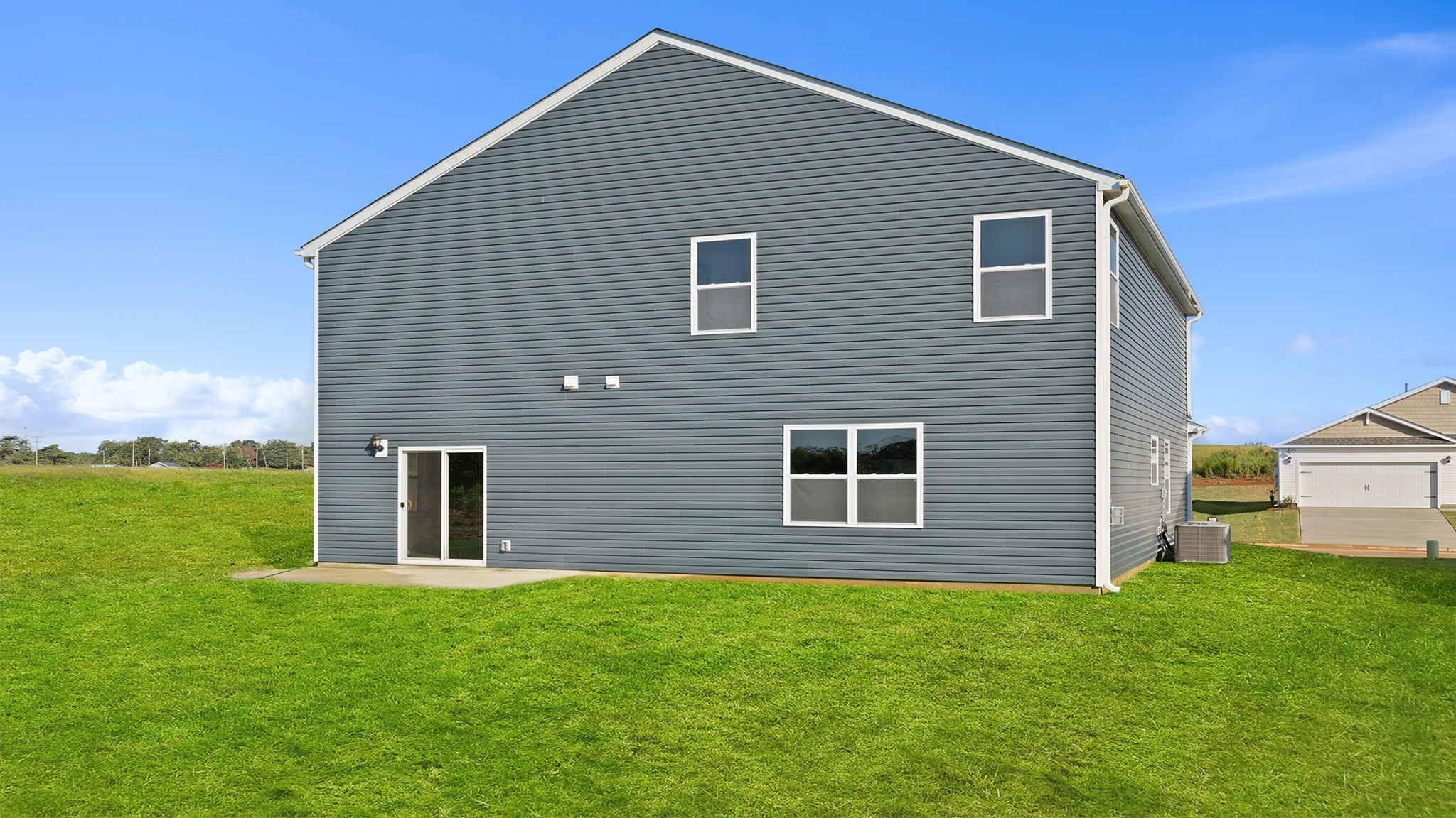 Back exterior of home with large backyard.