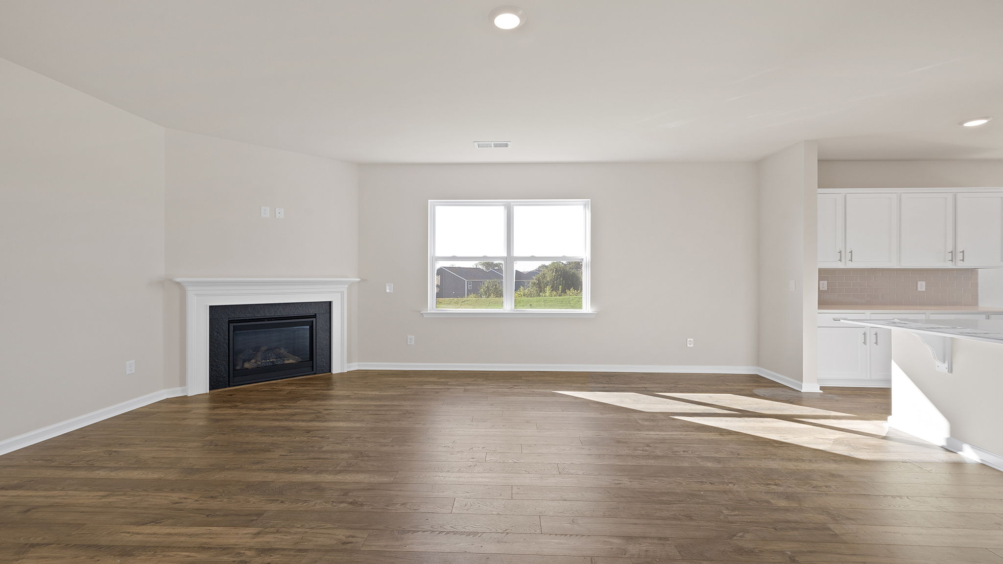 Family room with fireplace and window.